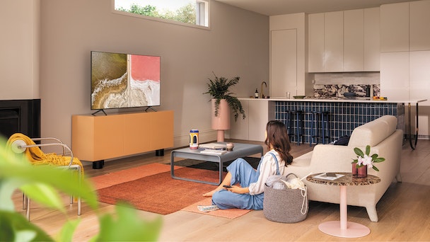 Woman in living room watching TV