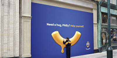 person hugging noodle billboard
