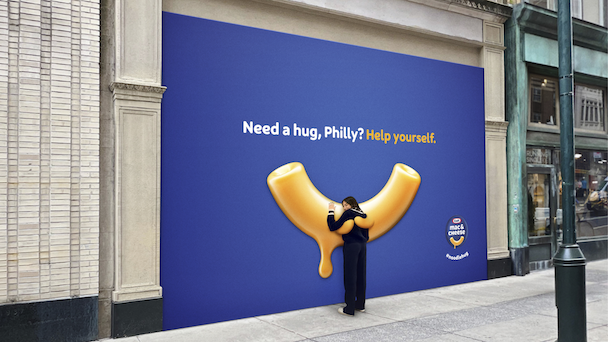 person hugging noodle billboard