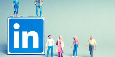 LinkedIn cube with logo and small plastic people figurines