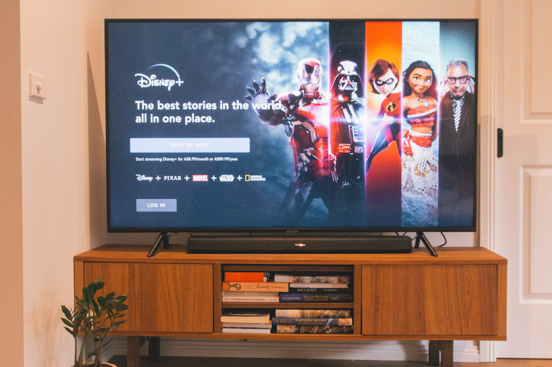 TV on console in living room with Disney Plus screen on display